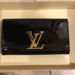 Louis Vuitton black patent leather clutch with gold buckle.